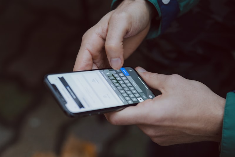 A hand holding a phone, mid-conversation.